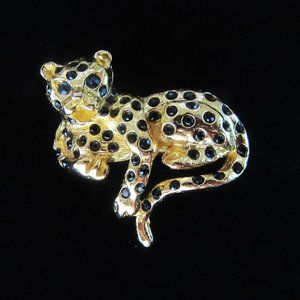 Vintage gold tone leopard brooch with blue/green rhinestone eyes